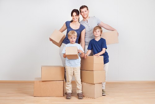 Packed office equipment and labelled boxes prepared for a Putney office move