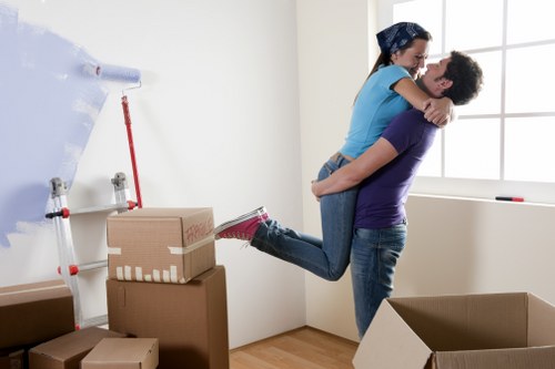 Professional movers handling desks and files during an office relocation in Putney