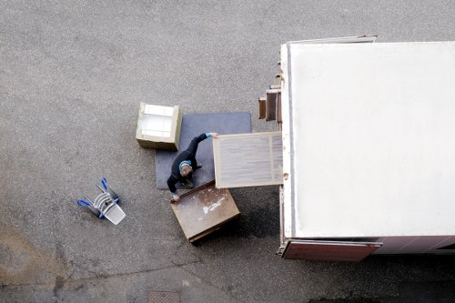 Professional movers transporting furniture from a Putney apartment building